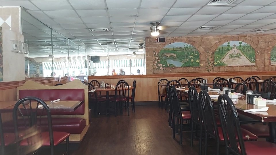 Old-fashioned restaurant interior with simple table settings.